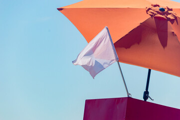 White flag on the beach as information for tourists for swimming is allowed.