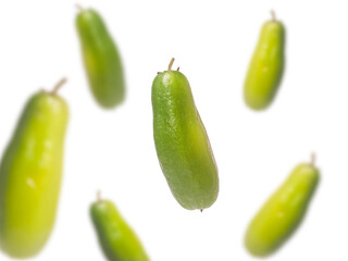 Fresh green bilimbi fruit, also known as Averrhoa bilimbi or belimbing wuluh, isolated on white background. Commonly used in Southeast Asian cuisine and traditional medicine.