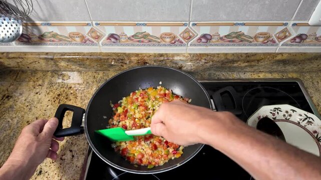Vegetarian home cooking featuring fresh peppers sizzling in pan, highlighting waste free culinary techniques with vibrant red and yellow vegetables in slow motion - Powered by Adobe