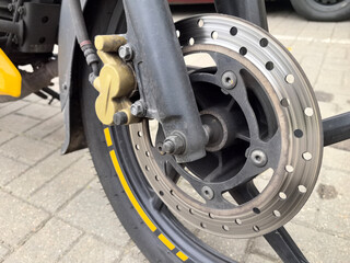 Exploring the intricate details of a motorcycle brake system on a sunny day