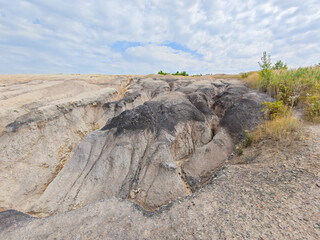 Tailings and waste sand  in  mined open pit coal quarry. Heavy erosion