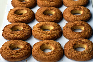 Background of round cookies. Cookies rings on white background. Many cookies biscuit , top view. Food background. Baked cookies with crumbs for Easter.