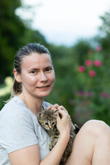 happy woman cuddling a kitten
