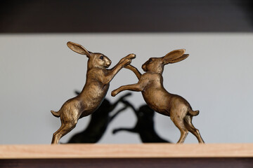 Bronze Hares Facing Each Other on Wooden Base © Holger