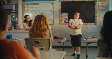 Primary School Boy Showcasing Knowledge of Ecology in Front of Class and Female Teacher. Smart Kids...