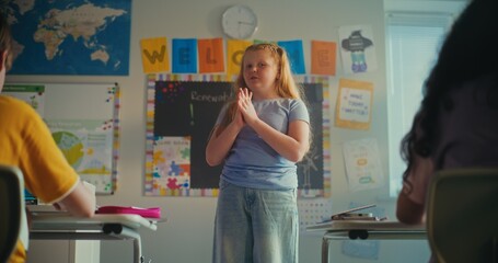 Smart Primary School Girl Showcasing Knowledge of Ecology in Front of Class and Teacher in Modern...