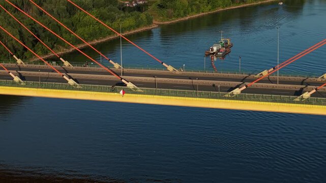 Aerial view of a bridge over the Vistula river, on which cars move. Warsaw, Poland. Siekierki (Siekierkowski) Bridge