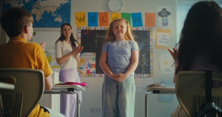 Shy Primary School Girl Showcasing Knowledge of Ecology in Front of Class and Teacher. Smart Kids...