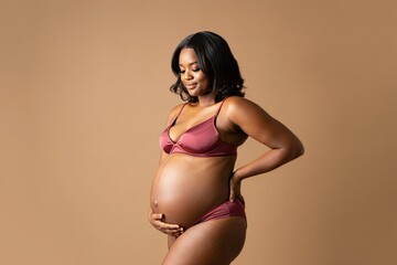 Radiant Black Woman in Lingerie, Embracing Baby Bump - Pregnancy Portrait