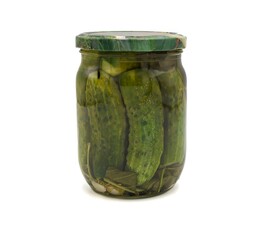 A single closed glass jar filled with whole cucumbers in brine and herbs. Traditional pickles, preserved vegetables, and rustic food concept. Isolated on white for commercial use.