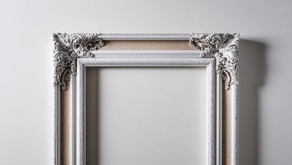 An antique silver frame featuring intricate carvings and texture.