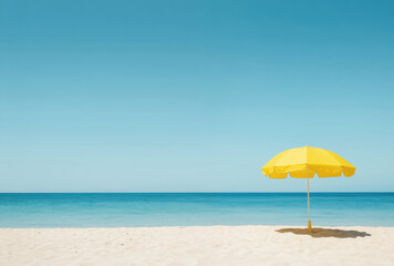 Bright yellow umbrella stands on serene sandy beach under clear blue sky. Gentle ocean waves meet shore. Midday sun provides shade, relaxation. Tropical paradise evokes summer vacation vibes,