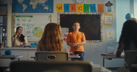 STEM Class on Renewable Energy: Female Teacher Calling Elementary School Student to the Board....