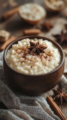 Delicious creamy rice pudding topped with spices and star anise in a rustic setting