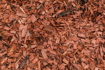 Dark Red Bark Chips Dust made from Cedar mulch Background 