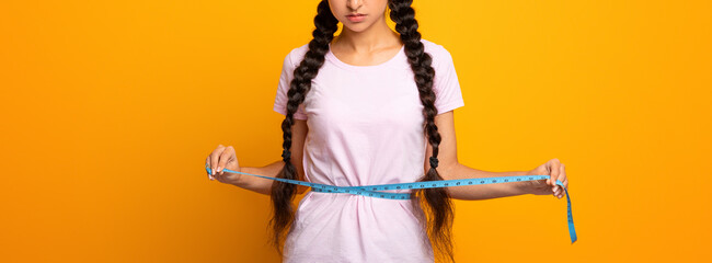 Weight Loss And Dieting. Sad And Disappointed Indian Woman Measuring Waist With Tape, Unhappy About...