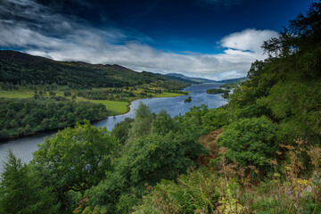 Scenic landscape of a riverside valley during a clear day in a serene countryside setting