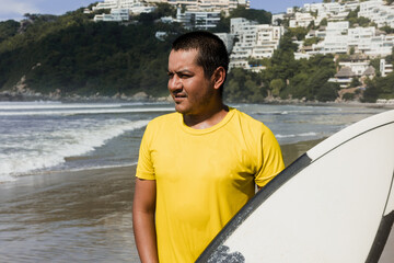 Latin surfer man rides the tropical waves in Mexico Latin America, hispanic people surfing in summer in sport activity concept 