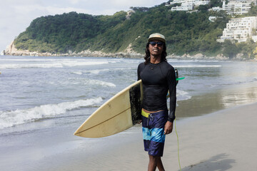 Latin surfer man rides the tropical waves in Mexico Latin America, hispanic people surfing in summer in sport activity concept 