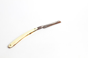 rusty straight razor isolated white background.