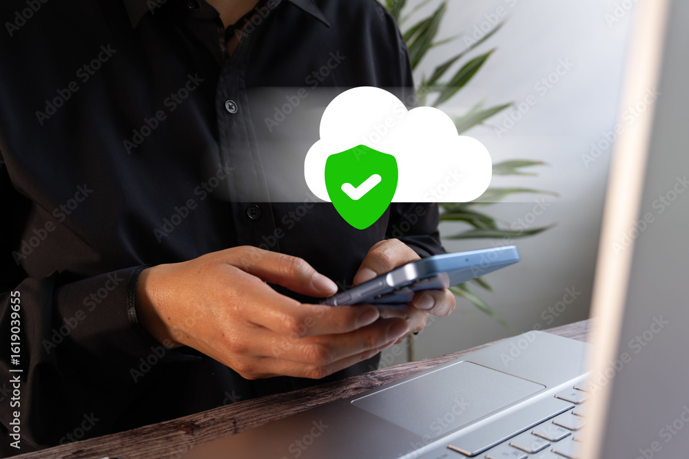 Aufkleber close-up of a person sitting in front of a laptop, holding a smartphone and a floating icon of a clo