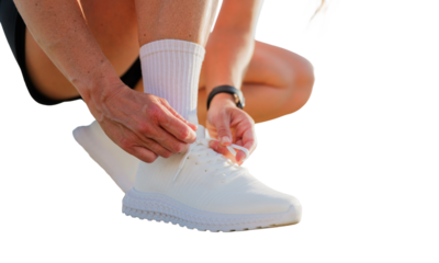 Lacing up fresh white sneakers for an energetic workout session