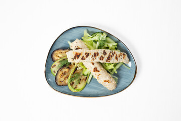 Grilled chicken kebabs with zucchini, eggplant, cucumber sticks, and fresh dill on a  plate. White background
