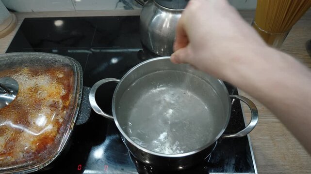 Detailed tutorial that offers simple and clear steps to make perfect pasta. Skilled hands simply throw the spaghetti into boiling water, ensuring delicious results every time