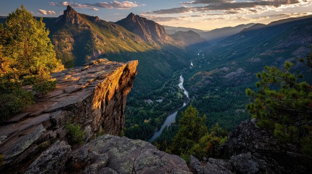 Mountain vista from a rocky overhang.  Sunset hues paint valley below