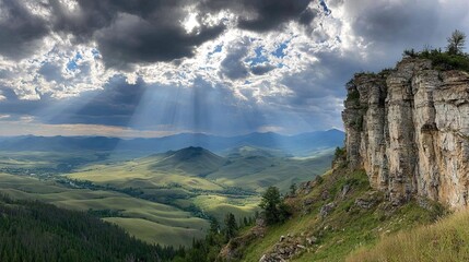 Fototapeta premium Mountain vista, sunbeams pierce clouds
