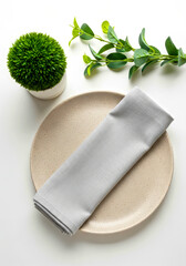Elegant Table Setting with Gray Napkin and Decorative Plant Accents