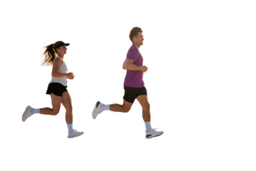 Energetic couple jogging against a bright backdrop in a serene setting