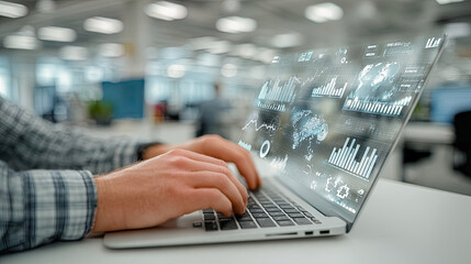 Businessman working with graphs and statistics on laptop in office