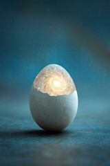 Cracked egg revealing swirling galaxy and glowing stars in surreal light
