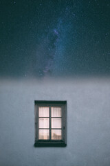 Simple window on white wall reveals a stunning starry night sky