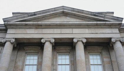 Classical stone architecture features prominent ionic columns supporting triangular pediment above windows. Building governmental judicial power, with strong neoclassical facade ideal for themes of