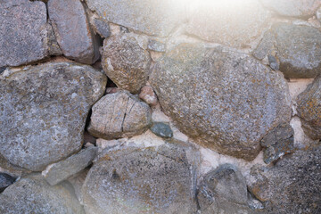 large rocks at the foot of the mountain on the beach
