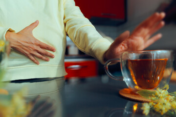 Person Suffers from Tea Intolerance Complaining of Stomach Pain. Woman having tea allergy refusing...