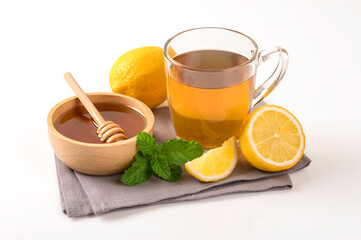 Hot of tea with lemon and honey in wooden bowl on white background.