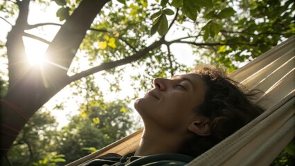 Relaxing Young Person Enjoying Nature in Hammock Under Sunny Tree