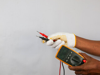 Close up male hand with glove hold digital multimeter and probe test.