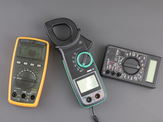 Top view digital Multimeter and digital clamp meter isolated on grey background.