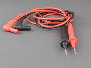 Multimeter probes on a grey background. Probes for electrical measurements.