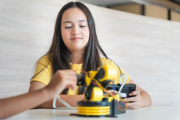 Young Asian Girl Learning Robotics and Engineering, STEM Education Focused Student Building a Robot, Future Innovator Teen Girl Engaged in Robotics Project