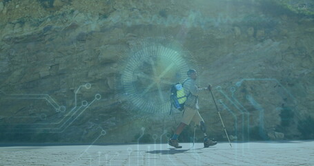 Hiking man with prosthetic leg navigating paved path at rocky cliff, tech overlay, copy space