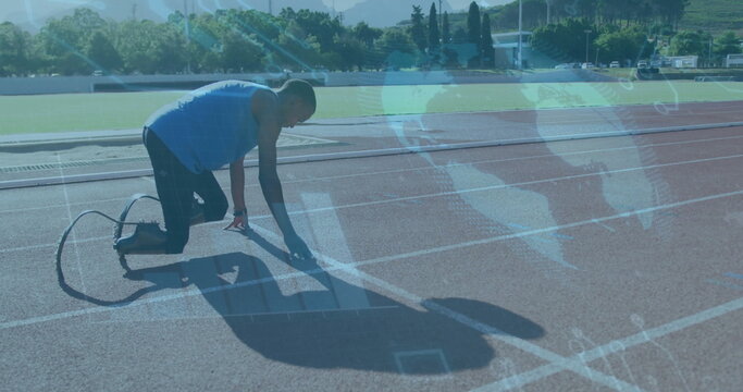 Fototapeta Kneeling athlete in gear placing hand and foot on track start line, gripping carbon fiber blade