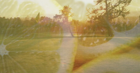 Casting long dawn shadows, flagstick standing on putting green, with pine trees and citrus overlay