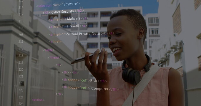 Dictating voice message woman with headphones holding smartphone on urban street, with code overlay - Powered by Adobe