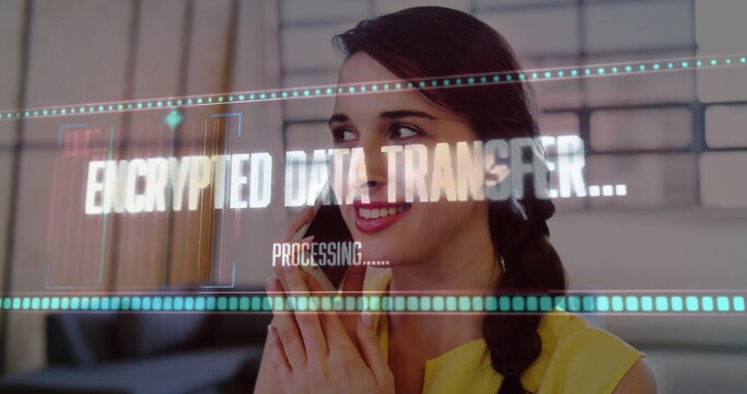 Viewing holographic display, woman in yellow blouse holding smartphone in office, encrypted overlay
