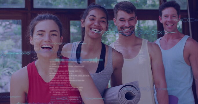 Fototapeta Smiling friends standing in fitness studio overlooking garden, holding rolled exercise mats